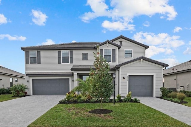 view of front of house featuring a garage and a front lawn