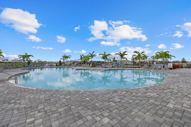 pool featuring a patio area and fence