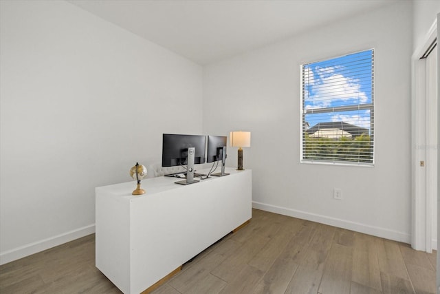 office area featuring light wood finished floors and baseboards