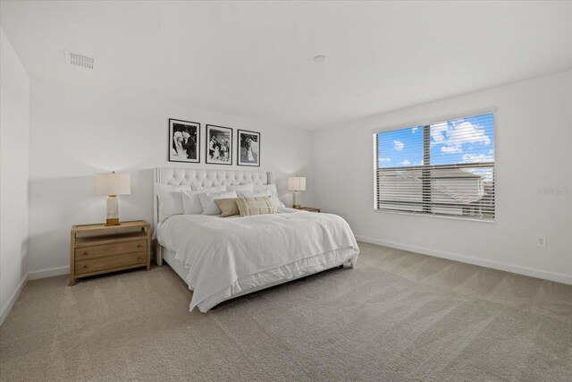 carpeted bedroom featuring visible vents and baseboards