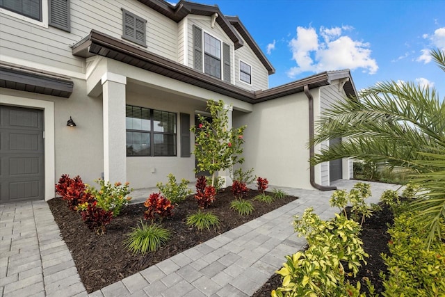 entrance to property featuring stucco siding