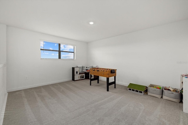 rec room with recessed lighting, light carpet, and baseboards