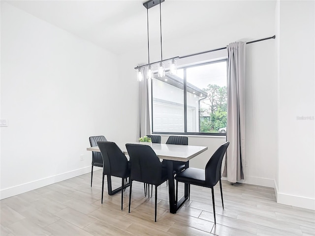 dining space with light hardwood / wood-style flooring