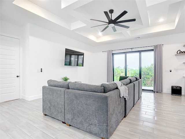 living room featuring ceiling fan and coffered ceiling