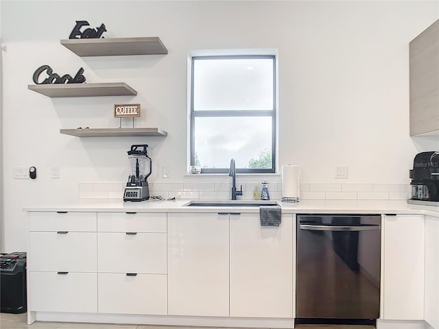 kitchen with white cabinetry, dishwasher, and sink