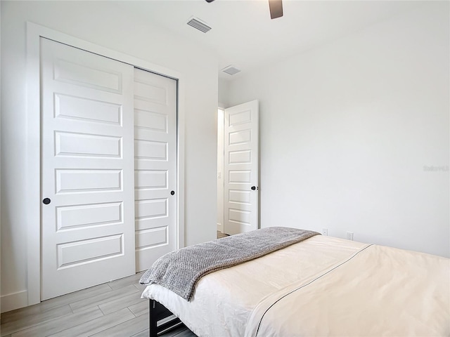 bedroom with ceiling fan and a closet