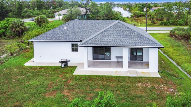 back of house featuring a patio area and a yard