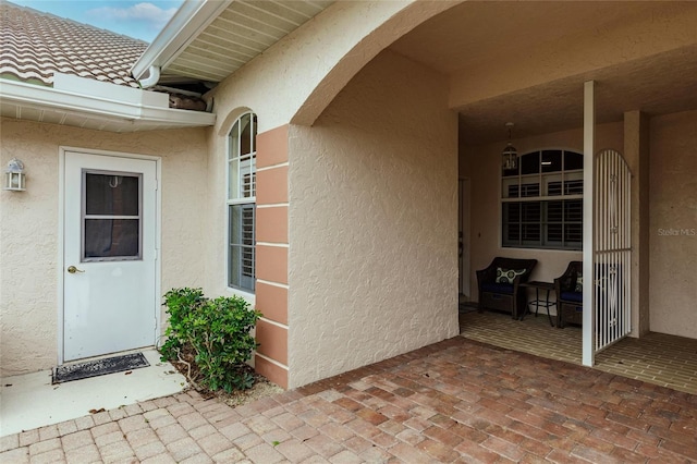 view of exterior entry featuring a patio