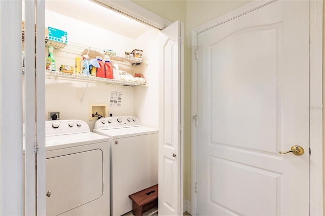 clothes washing area with washing machine and dryer