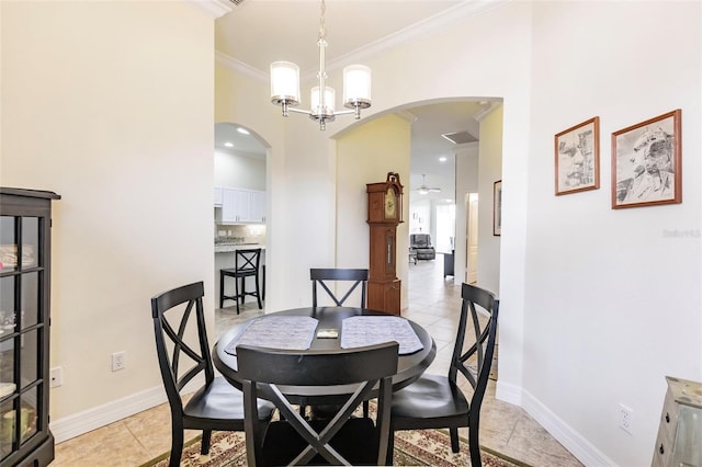 tiled dining space with an inviting chandelier and ornamental molding