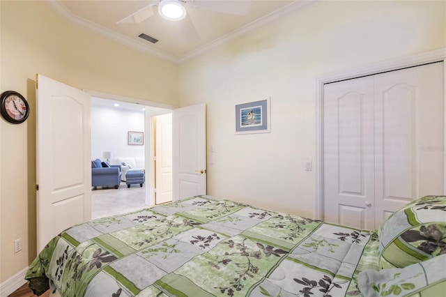 bedroom featuring ceiling fan, a closet, and ornamental molding