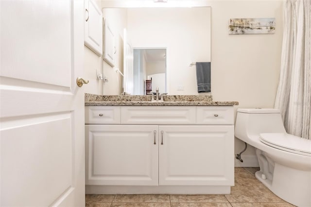 bathroom featuring toilet, tile patterned floors, and vanity