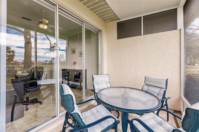 sunroom / solarium featuring ceiling fan