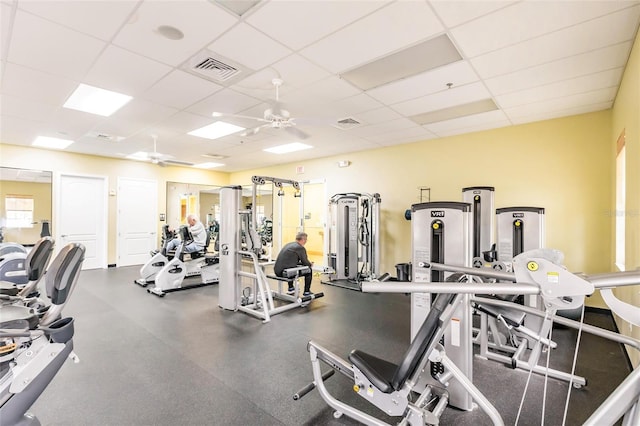 workout area with ceiling fan and a paneled ceiling