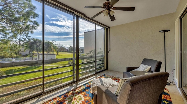 sunroom / solarium featuring ceiling fan