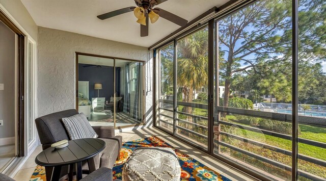 sunroom / solarium featuring ceiling fan