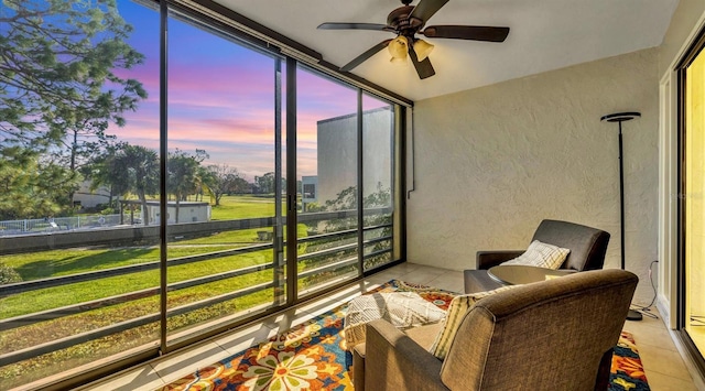 sunroom featuring ceiling fan