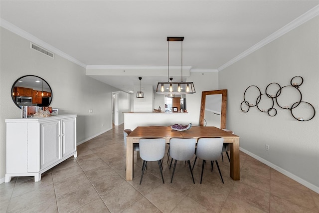 dining area featuring light tile patterned floors and ornamental molding