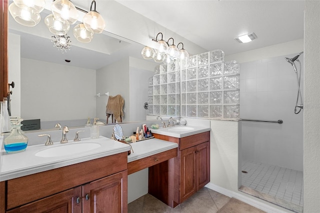 bathroom with vanity, tile patterned floors, and tiled shower