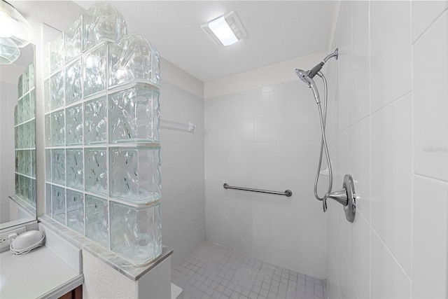 bathroom with tiled shower