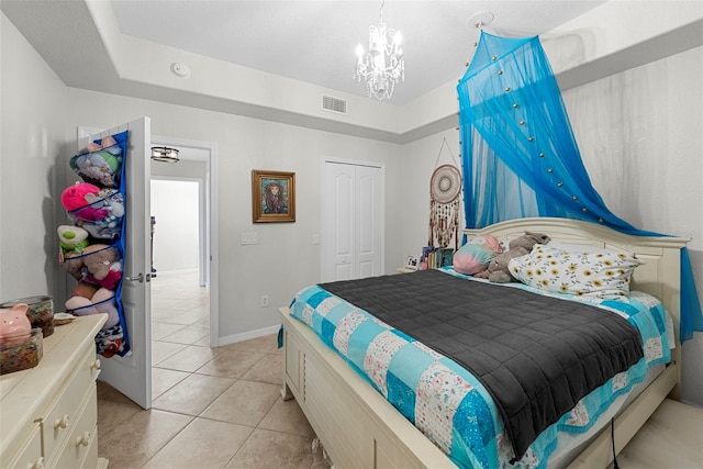 bedroom with a notable chandelier, a closet, and light tile patterned flooring