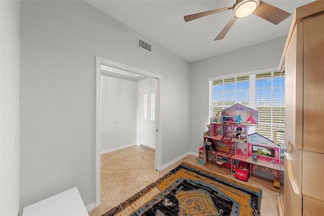 rec room with light tile patterned floors and ceiling fan