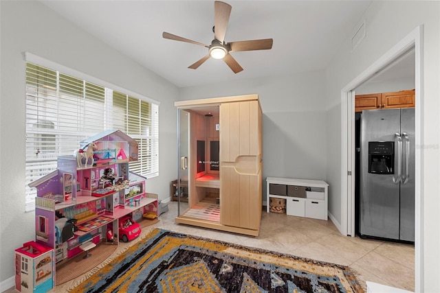 game room featuring ceiling fan and light tile patterned flooring