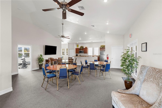 dining space with carpet flooring and high vaulted ceiling