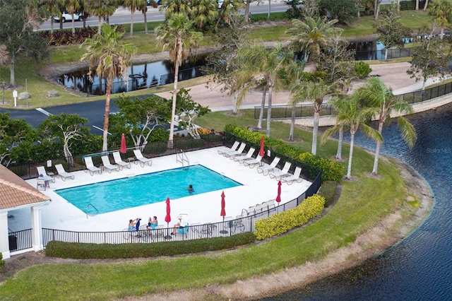 view of pool with a water view and a patio area