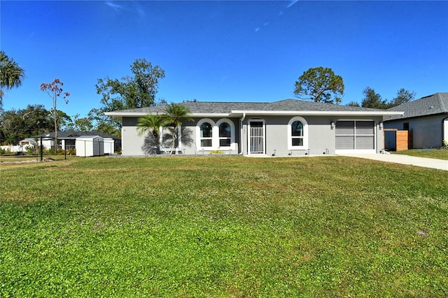 single story home featuring a front lawn and a garage