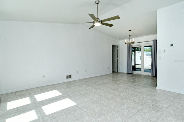 spare room with vaulted ceiling and ceiling fan with notable chandelier