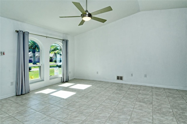 unfurnished room featuring lofted ceiling, ceiling fan, and light tile patterned flooring