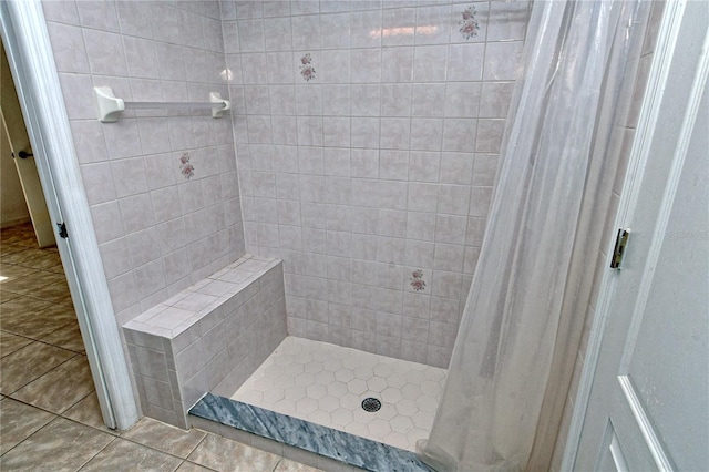 bathroom featuring curtained shower and tile patterned flooring