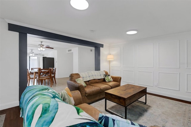 living room featuring ceiling fan and hardwood / wood-style floors