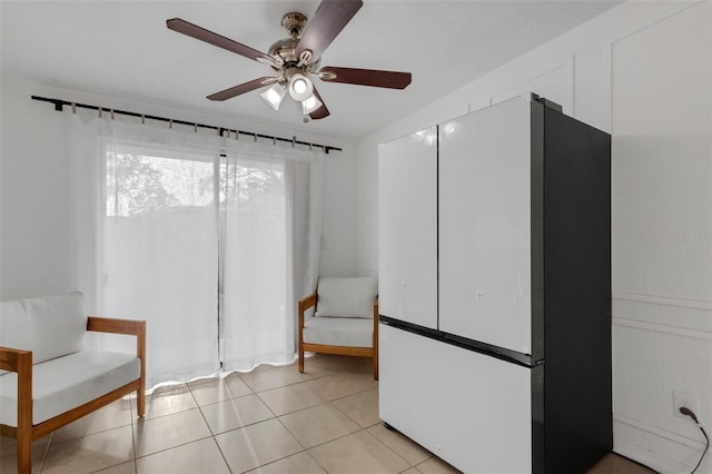 unfurnished room featuring ceiling fan and light tile patterned floors