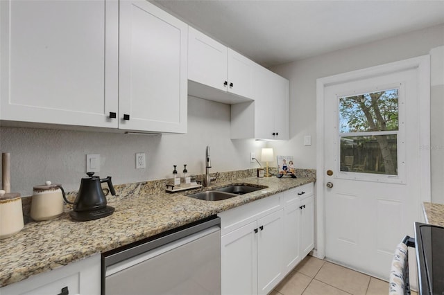 kitchen with light stone counters, sink, white cabinetry, and dishwasher