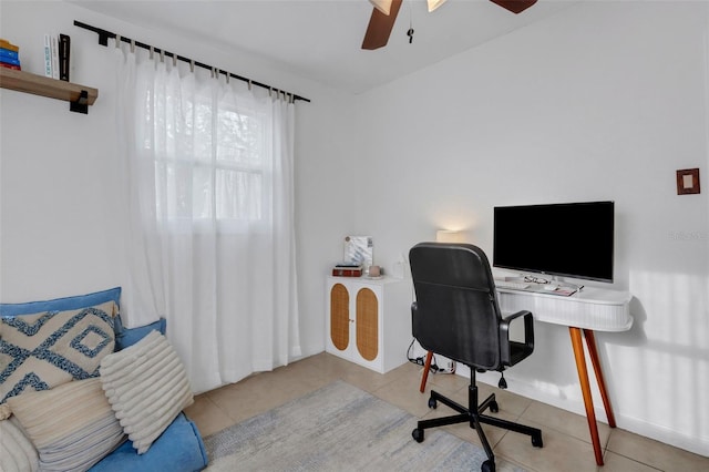 tiled home office featuring ceiling fan