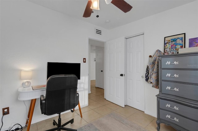 tiled office space featuring ceiling fan