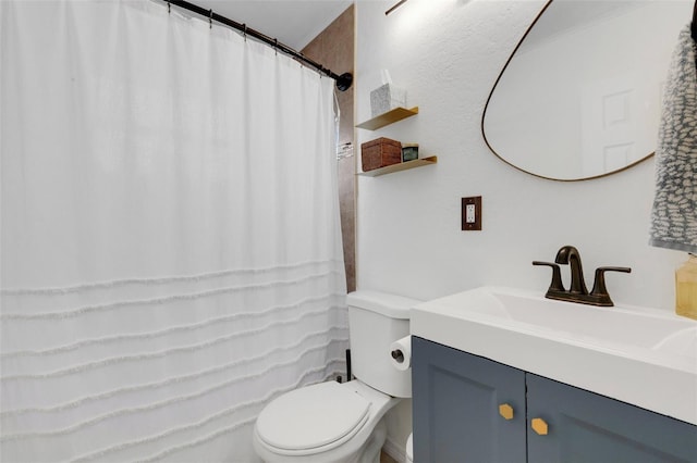 bathroom featuring toilet and vanity