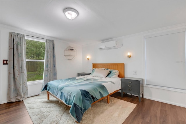 bedroom with an AC wall unit, dark hardwood / wood-style flooring, and ornamental molding