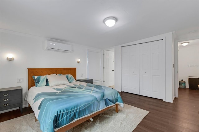 bedroom with dark hardwood / wood-style flooring, a closet, and a wall mounted air conditioner