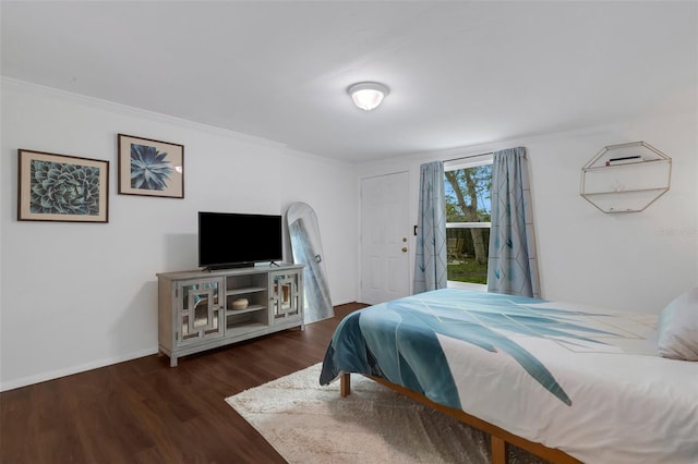 bedroom featuring dark hardwood / wood-style floors and crown molding