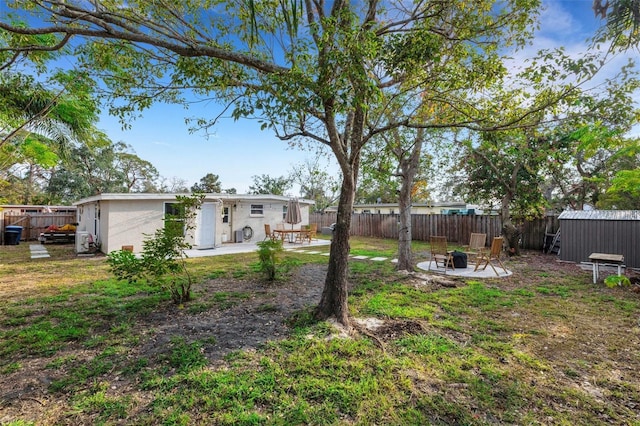 view of yard with a fire pit and a patio