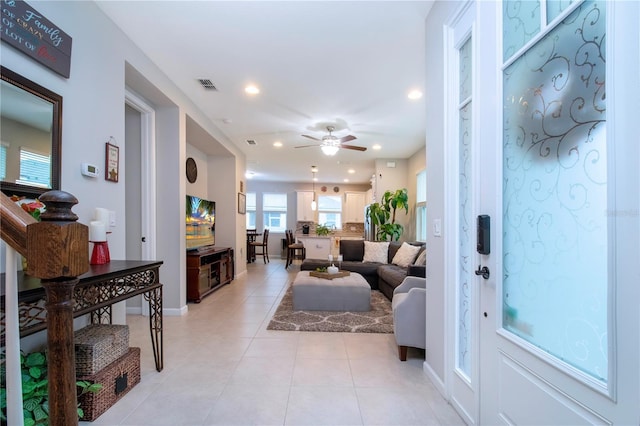 tiled entrance foyer with ceiling fan