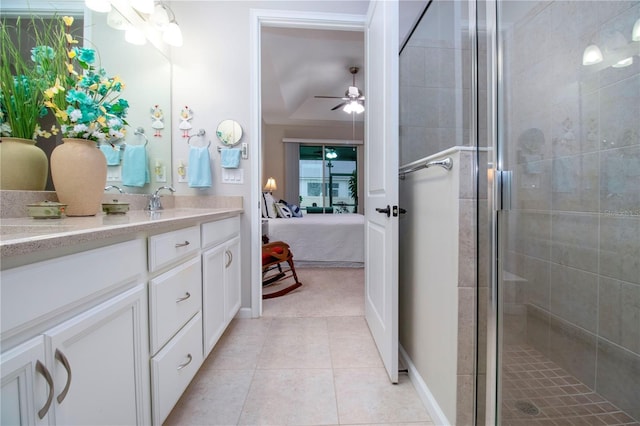 bathroom with vanity, a shower with shower door, ceiling fan, and tile patterned floors