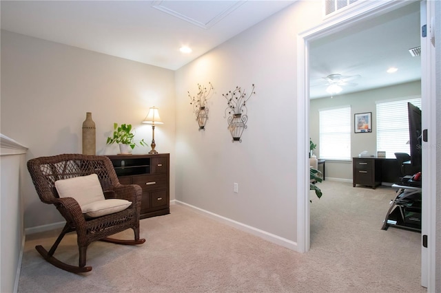 sitting room featuring ceiling fan and light colored carpet