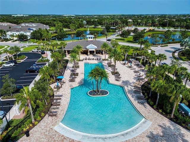 view of swimming pool with a patio area and a water view