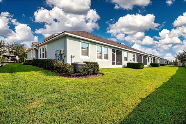11728 Meadowgate Pl, Bradenton, FL 34211 - back of property featuring stucco siding, a yard, and central air condition unit