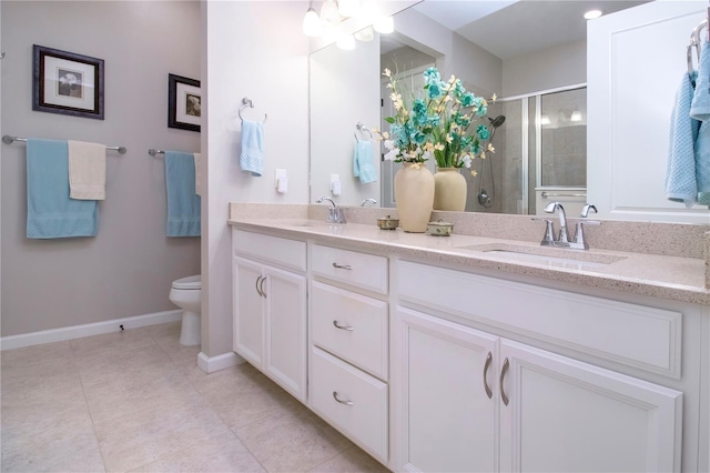 11728 Meadowgate Pl, Bradenton, FL 34211 - bathroom featuring toilet, double vanity, a stall shower, baseboards, and tile patterned floors