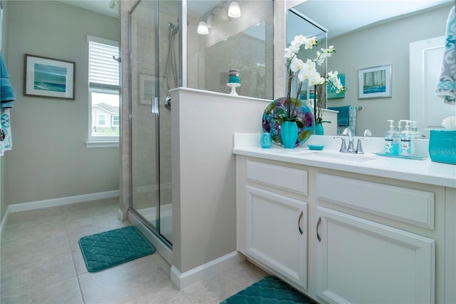 11728 Meadowgate Pl, Bradenton, FL 34211 - bathroom featuring vanity, a stall shower, tile patterned floors, and baseboards